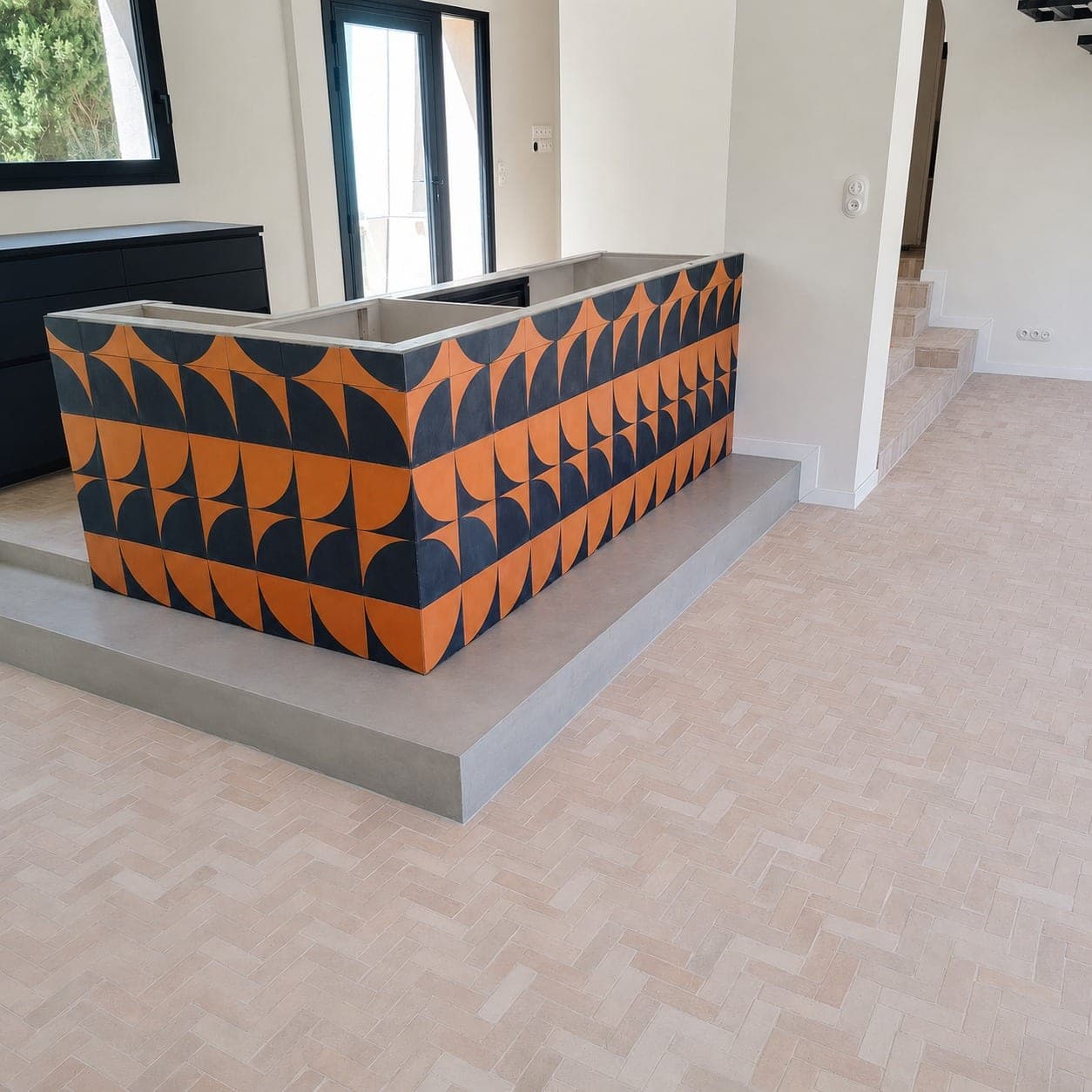 Comptoir ou habillage bas en carreaux décoratifs orange et bleu.